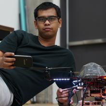 Jit Ray Chowdhury with quadrotor drone at Carnegie Mellon University